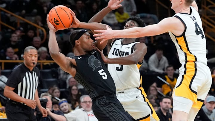 Iowa guards Drew Thelwell (3) and Josh Dix (4) trap Michigan State guard Tre Holloman (5) during a Big Ten Conference game Thursday, March 6, 2025 at Carver-Hawkeye Arena in Iowa City.