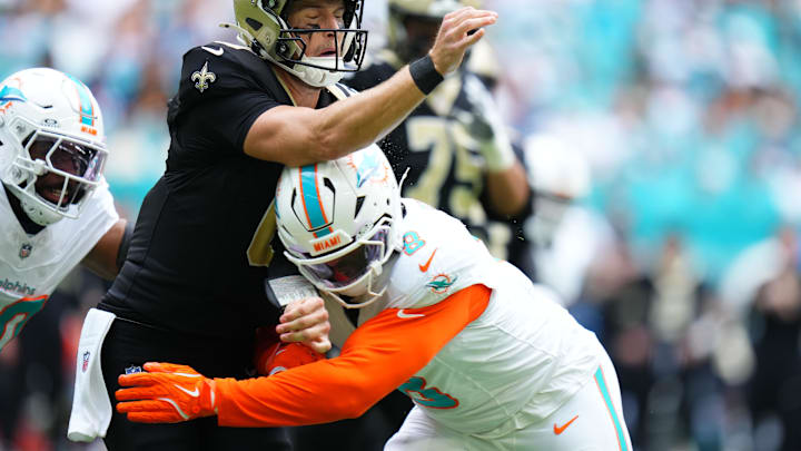 Nov 30, 2025; Miami Gardens, Florida, USA; Miami Dolphins linebacker Matthew Judon (8) puts a hit on New Orleans Saints quarterback Tyler Shough (6) a during the first half at Hard Rock Stadium. 
