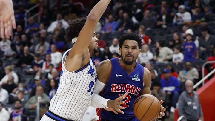 Oct 29, 2025; Detroit, Michigan, USA;  Detroit Pistons forward Tobias Harris (12) dribbles while defended by Orlando Magic forward Noah Penda (93) in the second half at Little Caesars Arena. Mandatory Credit: Rick Osentoski-Imagn Images
