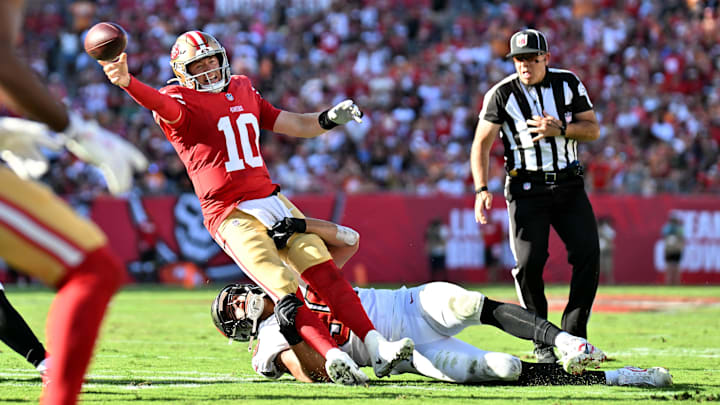 San Francisco 49ers quarterback Mac Jones (10) tackled by Tampa Bay Buccaneers linebacker Anthony Nelson (98) San Francisco 49ers quarterback Mac Jones (10) tackled by Tampa Bay Buccaneers linebacker Anthony Nelson (98)