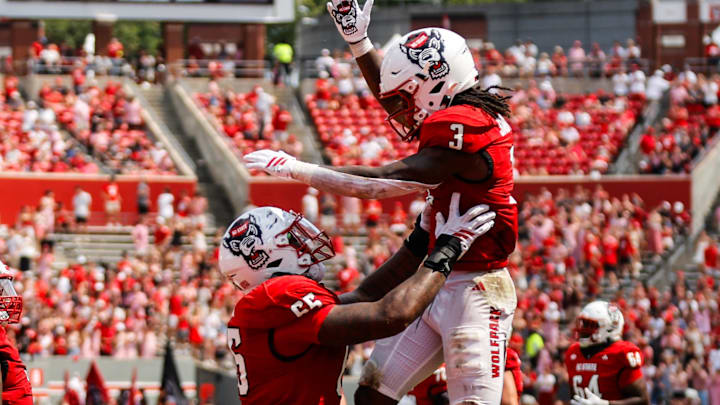 Sep 6, 2025; Raleigh, North Carolina, USA; North Carolina State Wolfpack running back Hollywood Smothers (3), and offensive lineman Matt McCabe (66) celebrate a touchdown during the second half of the game against Virginia Cavaliers at Carter-Finley Stadium. Mandatory Credit: Jaylynn Nash-Imagn Images