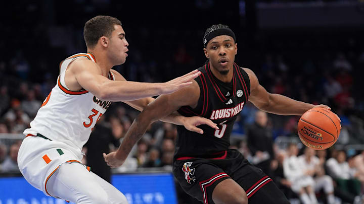 Mar 12, 2026; Charlotte, NC, USA; Louisville Cardinals guard Ryan Conwell (3) handles the ball against Miami (FL) Hurricanes guard Dante Allen (35) during the second half at Spectrum Center. Mandatory Credit: Jim Dedmon-Imagn Images