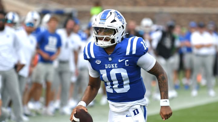 Sep 6, 2025; Durham, North Carolina, USA;  Duke Blue Devils quarterback Darian Mensah (10) runs against the Illinois Fighting Illini during the third quarter at Wallace Wade Stadium. Mandatory Credit: Zachary Taft-Imagn Images