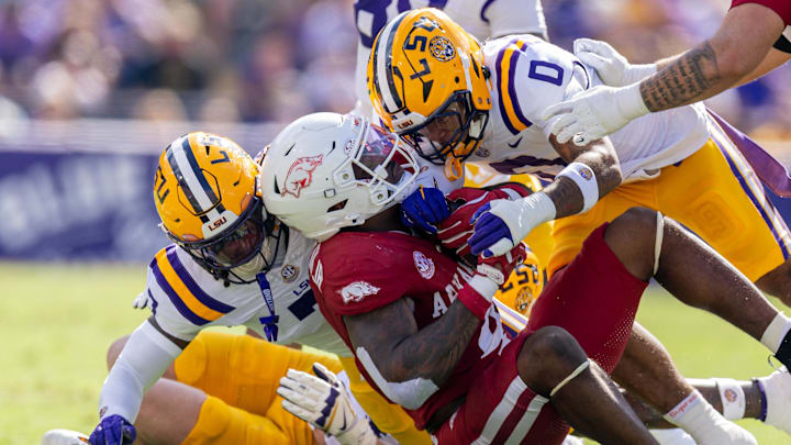 Arkansas Razorbacks running back Mike Washington (4) is tackled by LSU Tigers safety Tamarcus Cooley (0) during the first half at Tiger Stadium in Baton Rouge, La.