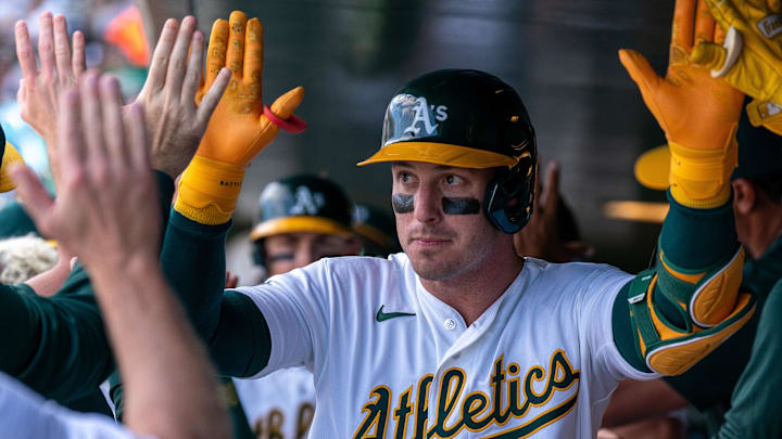 Athletics right fielder Brent Rooker (25) celebrates in the dugout with teammates after hitting a two run home run against the Houston Astros during the seventh inning at Sutter Health Park. Athletics right fielder Brent Rooker (25) celebrates in the dugout with teammates after hitting a two run home run against the Houston Astros during the seventh inning at Sutter Health Park.