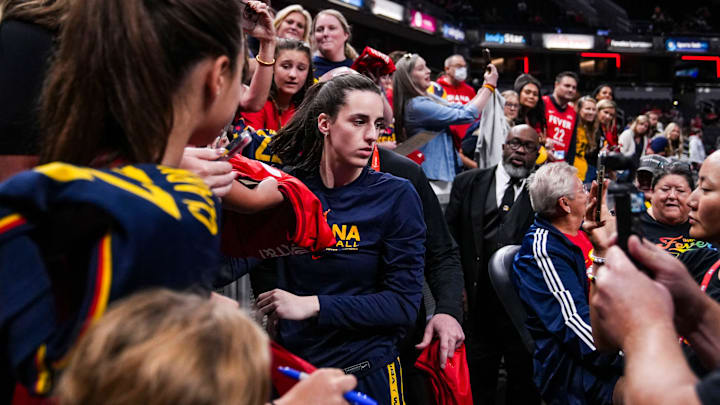 Indiana Fever guard Caitlin Clark (22) signs merchandise Friday, Sept. 6, 2024, during a game between the Indiana Fever and the Minnesota Lynx at Gainbride Fieldhouse in Indianapolis.