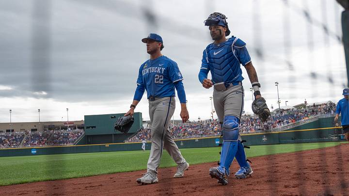 Jun 19, 2024; Omaha, NE, USA;  Kentucky Wildcats starting pitcher Dominic Niman (22) and catcher Devin Burkes (7) walk to the dugout before the game at Charles Schwab Field Omaha. Mandatory Credit: Steven Branscombe-USA TODAY Sports