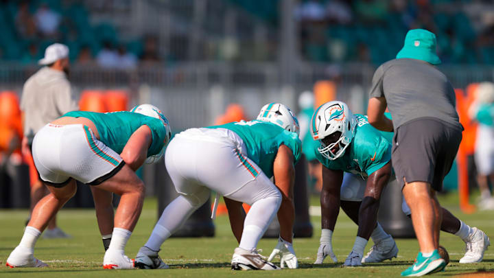 Miami Dolphins defensive tackle Matthew Butler (91) works with defensive end Matt Dickerson (98) during training camp at Baptist Health Training Complex. 