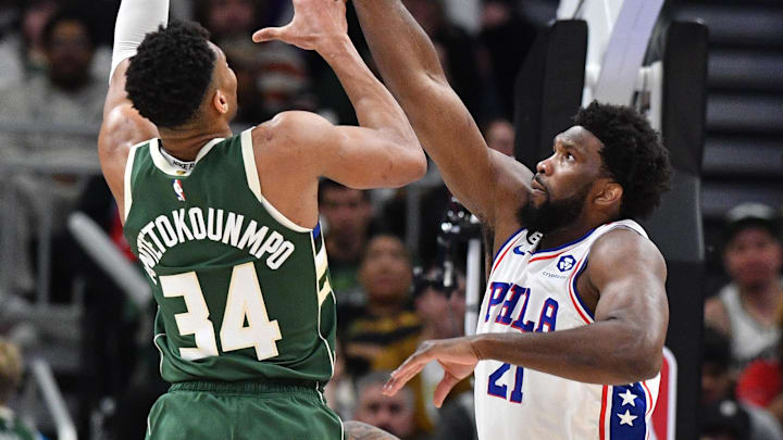 Mar 4, 2023; Milwaukee, Wisconsin, USA; Milwaukee Bucks forward Giannis Antetokounmpo (34) puts up a shot against Philadelphia 76ers center Joel Embiid (21) in the second half at Fiserv Forum. Mandatory Credit: Michael McLoone-Imagn Images