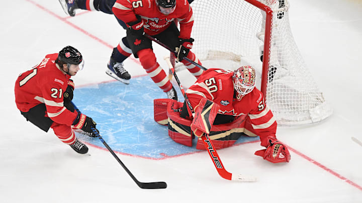 Feb 20, 2025; Boston, MA, USA; [Imagn Images direct customers only]  Team USA forward Matt Boldy (12) crashes into the net of Team Canada goaltender Jordan Binnington (50) as forward Brayden Point (21) and defenseman Devon Toews (5) defend against a shot during the third period during the 4 Nations Face-Off ice hockey championship game at TD Garden. Mandatory Credit: Brian Fluharty-Imagn Images