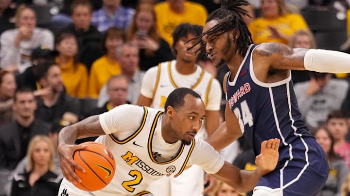 Nov 8, 2024; Columbia, Missouri, USA; Missouri Tigers guard Tamar Bates (2) controls the ball as Howard Bison guard Bryce Harris (34) defends during the second half at Mizzou Arena. Mandatory Credit: Denny Medley-Imagn Images