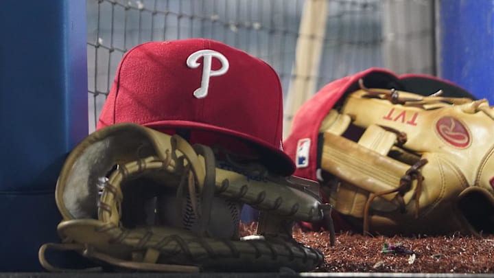 Aug 16, 2023; Toronto, Ontario, CAN; A Philadelphia Phillies cap and glove sit in the dugout during a game against the Toronto Blue Jays at Rogers Centre. Mandatory Credit: John E. Sokolowski-Imagn Images Aug 16, 2023; Toronto, Ontario, CAN; A Philadelphia Phillies cap and glove sit in the dugout during a game against the Toronto Blue Jays at Rogers Centre. Mandatory Credit: John E. Sokolowski-Imagn Images