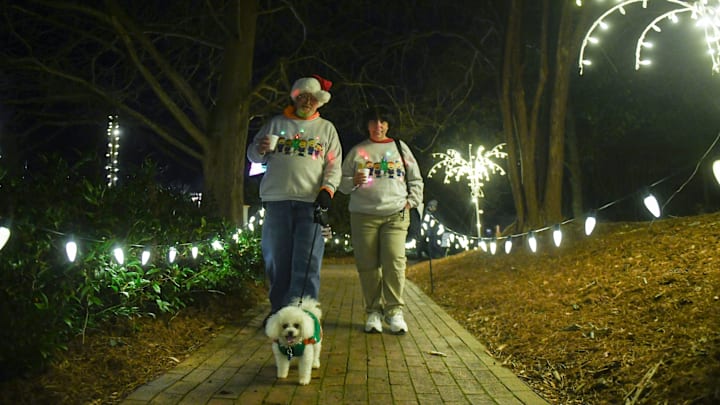 Richard and Mary Peterson walk with their dog Peebles through Hopelands Gardens in Aiken, S.C., on