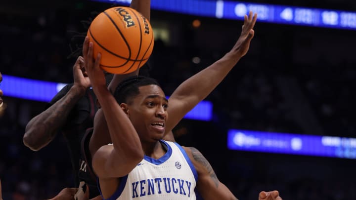 Kentucky Wildcats guard Rob Dillingham (0) looks to pass the ball under pressure during their quarterfinal game against Texas A&M of the SEC Men's Basketball Tournament at Bridgestone Arena in Nashville, Tenn., Friday, March 15, 2024.
