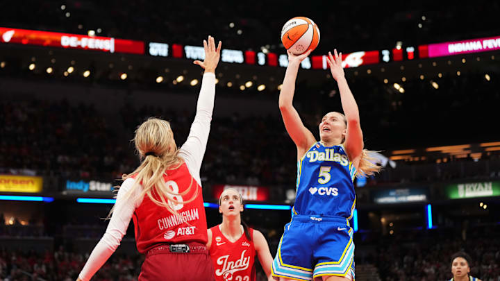 Paige Bueckers (right) had 20 points in the Wings’ opening win on the road against the Fever. 