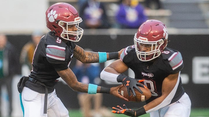 Louisville's quarterback Zavier Hunt (9) hands off to Zaiden Jernigan (8) during play against Louisville in the MHSAA 4A championship game in Hattiesburg, Miss., Saturday, Dec. 7, 2024.