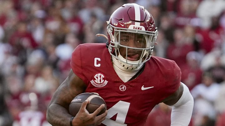 Nov 30, 2024; Tuscaloosa, Alabama, USA;  Alabama Crimson Tide quarterback Jalen Milroe (4) runs for a touchdown against the Auburn Tigers during the first half at Bryant-Denny Stadium. Mandatory Credit: Gary Cosby Jr.-Imagn Images