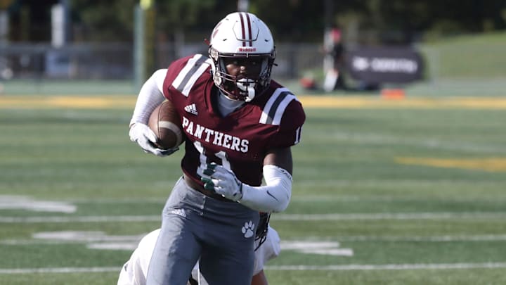 River Rouge receiver Nicholas Marsh makes a catch against Cedar Springs defensive back Ryan Mitchell
