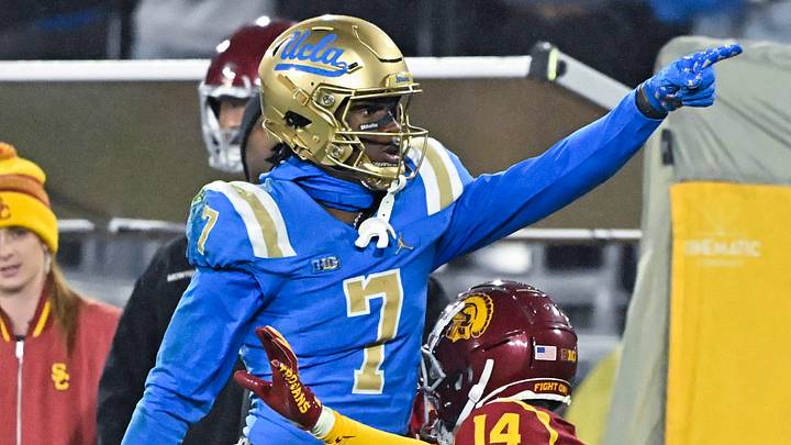 Nov 23, 2024; Pasadena, California, USA; UCLA Bruins wide receiver J.Michael Sturdivant (7) signals a first down after catching a long pass over USC Trojans cornerback Jacobe Covington (14) in the third quarter at Rose Bowl. Mandatory Credit: Robert Hanashiro-Imagn Images