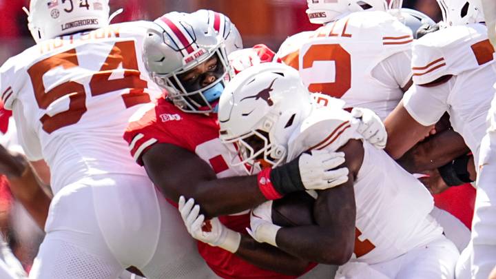Ohio State Buckeyes defensive lineman Kayden McDonald (98) tackles Texas Longhorns running back CJ Baxter (4) during the NCAA football game at Ohio Stadium on Aug. 30, 2025. Ohio State Buckeyes defensive lineman Kayden McDonald (98) tackles Texas Longhorns running back CJ Baxter (4) during the NCAA football game at Ohio Stadium on Aug. 30, 2025.