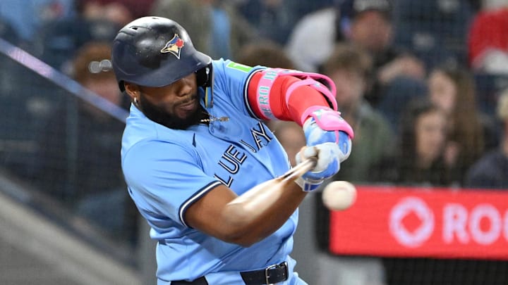 Apr 20, 2025; Toronto, Ontario, CAN;  Toronto Blue Jays first baseman Vladimir Guerrero Jr. (27) hits a single against the Seattle Mariners in the fourth inning at Rogers Centre. 