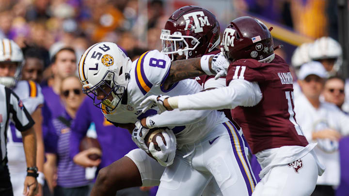 Nov 25, 2023; Baton Rouge, Louisiana, USA; LSU Tigers wide receiver Malik Nabers (8) rushes against Texas A&M Aggies defensive back Deuce Harmon (11) during the first half at Tiger Stadium. Mandatory Credit: Stephen Lew-Imagn Images Nov 25, 2023; Baton Rouge, Louisiana, USA; LSU Tigers wide receiver Malik Nabers (8) rushes against Texas A&M Aggies defensive back Deuce Harmon (11) during the first half at Tiger Stadium. Mandatory Credit: Stephen Lew-Imagn Images