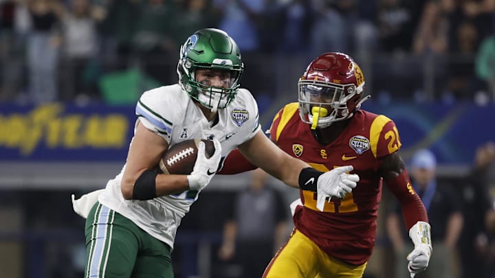 Jan 2, 2023; Arlington, Texas, USA; Tulane Green Wave tight end Alex Bauman (87) runs with the ball after catching a pass against USC Trojans defensive back Latrell McCutchin (21)in the fourth quarter in the 2023 Cotton Bowl at AT&T Stadium. Mandatory Credit: Tim Heitman-Imagn Images Jan 2, 2023; Arlington, Texas, USA; Tulane Green Wave tight end Alex Bauman (87) runs with the ball after catching a pass against USC Trojans defensive back Latrell McCutchin (21)in the fourth quarter in the 2023 Cotton Bowl at AT&T Stadium. Mandatory Credit: Tim Heitman-Imagn Images