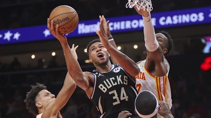 Nov 7, 2022; Atlanta, Georgia, USA; Milwaukee Bucks forward Giannis Antetokounmpo (34) shoots past Atlanta Hawks forward Jalen Johnson (1) and forward Onyeka Okongwu (17) in the third quarter at State Farm Arena. Mandatory Credit: Brett Davis-Imagn Images