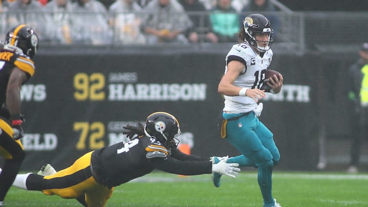 Jacksonville Jaguars Trevor Lawrence (16) slips away from Pittsburgh Steelers Armon Watts (94) while