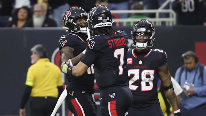 Jan 11, 2025; Houston, Texas, USA;  Houston Texans quarterback C.J. Stroud (7) celebrates wide receiver Nico Collins (12) touchdown against the Los Angeles Chargers in the second quarter in an AFC wild card game at NRG Stadium. Mandatory Credit: Thomas Shea-Imagn Images