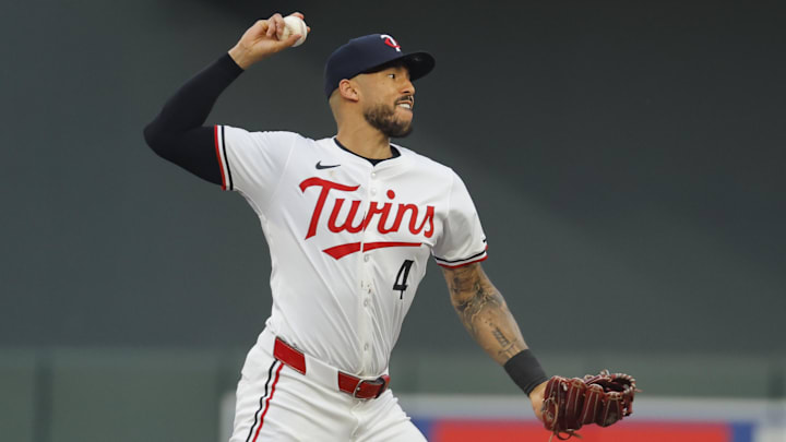 Sep 14, 2024; Minneapolis, Minnesota, USA; Minnesota Twins' Carlos Correa (4) turns a double play against the Cincinnati Reds in the second inning at Target Field. Mandatory Credit: Bruce Kluckhohn-Imagn Images