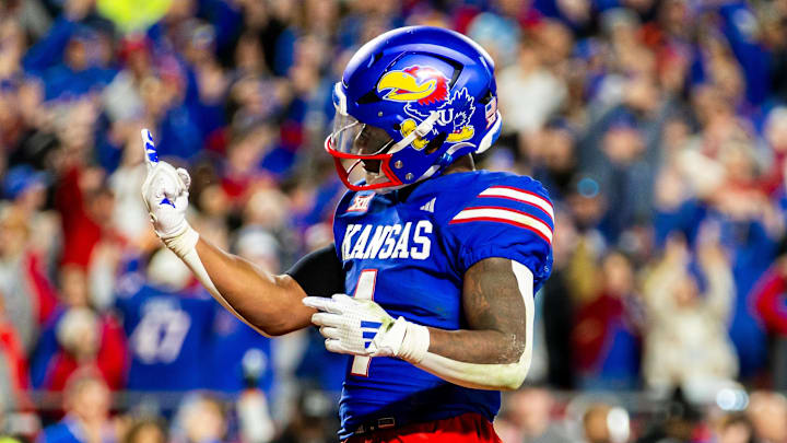 Nov 23, 2024; Kansas City, Missouri, USA;  Kansas running back Devin Neal (4) gestures after scoring a touchdown during the 4th quarter between the Kansas Jayhawks and the Colorado Buffaloes.