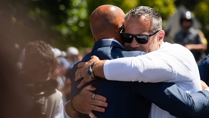 Penn State Athletic Director Pat Kraft, center, greets head football coach James Franklin before the Nittany Lions' game vs. Nevada. 