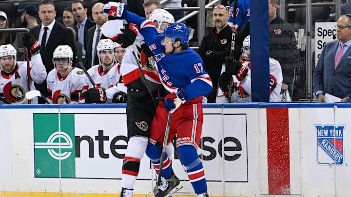Jan 21, 2025; New York, New York, USA;  New York Rangers defenseman Will Borgen (17) and Ottawa Senators left wing Brady Tkachuk (7) collide along the boards during the third period at Madison Square Garden. Mandatory Credit: Dennis Schneidler-Imagn Images