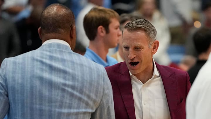 Dec 4, 2024; Chapel Hill, North Carolina, USA;  Alabama Crimson Tide head coach Nate Oats greets North Carolina Tar Heels head coach Hubert Davis before the game at Dean E. Smith Center. Mandatory Credit: Bob Donnan-Imagn Images
