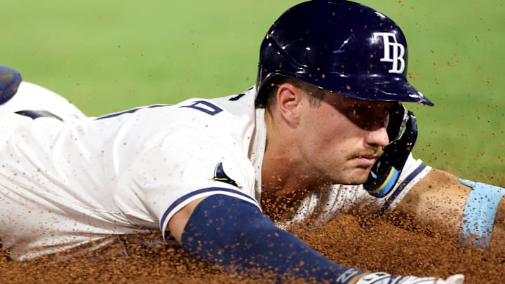 Apr 1, 2025; St. Petersburg, Florida, USA; Tampa Bay Rays center fielder Jonny DeLuca (21) slides into third base after hitting a triple against the Pittsburgh Pirates in the eighth inning at George M. Steinbrenner Field. Apr 1, 2025; St. Petersburg, Florida, USA; Tampa Bay Rays center fielder Jonny DeLuca (21) slides into third base after hitting a triple against the Pittsburgh Pirates in the eighth inning at George M. Steinbrenner Field.