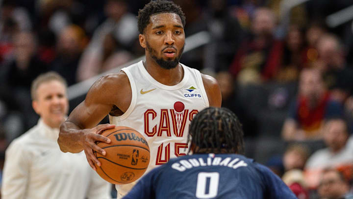 Oct 26, 2024; Washington, District of Columbia, USA; Cleveland Cavaliers guard Donovan Mitchell (45) dribbles the ball against Washington Wizards guard Bilal Coulibaly (0) during the third quarter at Capital One Arena. Mandatory Credit: Reggie Hildred-Imagn Images