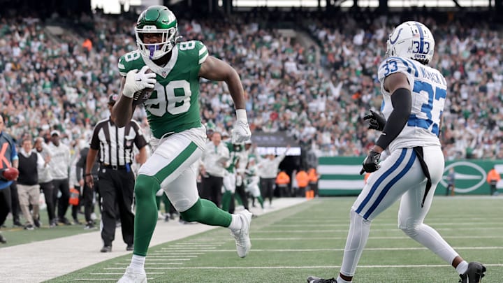 Nov 17, 2024; East Rutherford, New Jersey, USA; New York Jets tight end Kenny Yeboah (88) scores a touchdown against Indianapolis Colts cornerback Samuel Womack III (33) during the fourth quarter at MetLife Stadium. Mandatory Credit: Brad Penner-Imagn Images