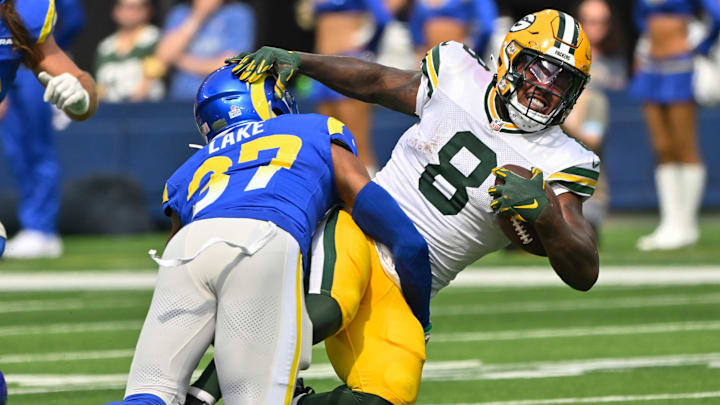 Oct 6, 2024; Inglewood, California, USA; Green Bay Packers running back Josh Jacobs (8) is tackled by Los Angeles Rams safety Quentin Lake (37) during the second quarter at SoFi Stadium. Mandatory Credit: Robert Hanashiro-Imagn Images