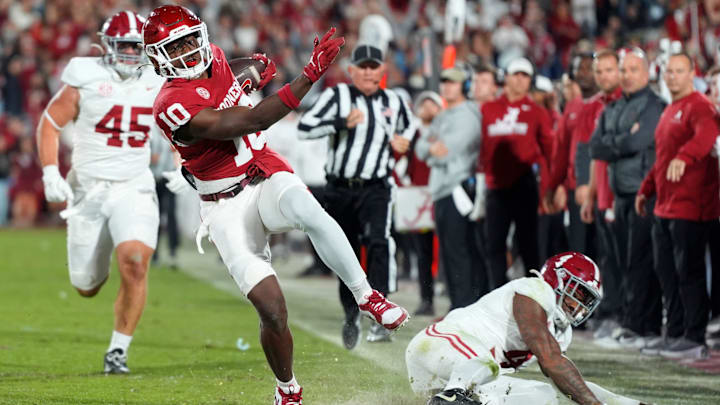 Oklahoma Sooners linebacker Kip Lewis returns an interception for a touchdown against the Alabama Crimson Tide. Oklahoma Sooners linebacker Kip Lewis returns an interception for a touchdown against the Alabama Crimson Tide.
