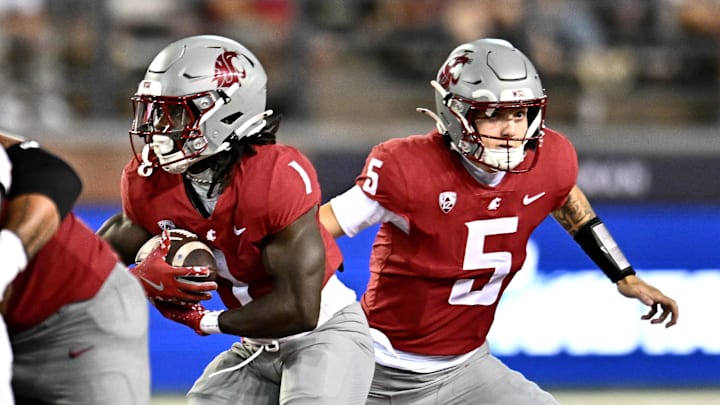 Washington State Cougars running back Angel Johnson (1) takes the handoff from Washington State Cougars quarterback Jaxon Potter (5). Washington State Cougars running back Angel Johnson (1) takes the handoff from Washington State Cougars quarterback Jaxon Potter (5).