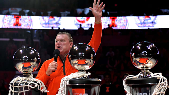 Nov 8, 2024; Champaign, Illinois, USA;  Illinois Fighting Illini head coach Brad Underwood displays the three consecutive Big 10 championship trophies before a game against the SIU Edwardsville Cougars at State Farm Center. Mandatory Credit: Ron Johnson-Imagn Images