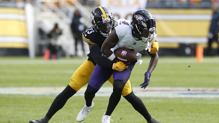 Oct 8, 2023; Pittsburgh, Pennsylvania, USA; Baltimore Ravens wide receiver Zay Flowers (4) is tackled after a catch by Pittsburgh Steelers safety Damontae Kazee (23) during the second quarter at Acrisure Stadium. Mandatory Credit: Charles LeClaire-Imagn Images