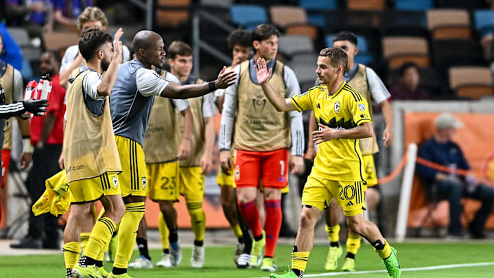 Mar 6, 2024; Houston, TX, USA; Columbus Crew midfielder Alexandru Matan (20) high fives teammates