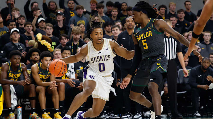 Nov 9, 2025; Waco, Texas, USA;  Washington Huskies guard Quimari Peterson (0) drives to the basket against Baylor Bears guard Obi Agbim (5) during the first half at Paul and Alejandra Foster Pavilion. Mandatory Credit: Chris Jones-Imagn Images