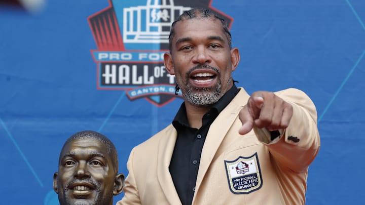 Aug 3, 2024; Canton, OH, USA;  Class of 2024 member Julius Peppers poses with his bust at the enshrinement ceremony at Tom Benson Hall of Fame Stadium. Mandatory Credit: Charles LeClaire-Imagn Images