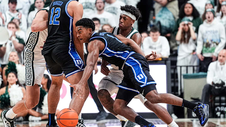 Duke guard Caleb Foster (1) dribbles against Michigan State guard Jeremy Fears Jr. (1) during the first half at Breslin Center in East Lansing on Saturday, Dec. 6, 2025.