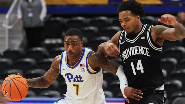 Oct 19, 2025; Pittsburgh, PA, USA;  Pittsburgh Panthers guard Damarco Minor (7) controls the ball against Providence Friars guard Corey Floyd Jr. (14) during the second half at the Petersen Events Center. Mandatory Credit: Charles LeClaire-Imagn Images