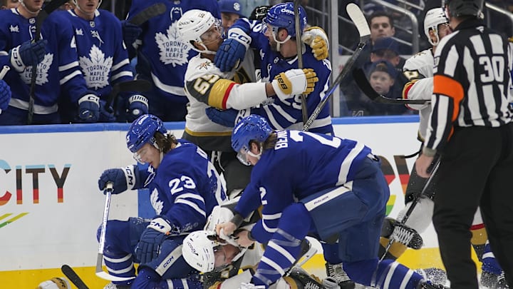 Nov 20, 2024; Toronto, Ontario, CAN; Toronto Maple Leafs defenseman Simon Benoit (2) fights with Vegas Golden Knights defenseman Zach Whitecloud (2) and forward Keegan Kolesar (55) fights with Toronto Maple Leafs defenseman Conor Timmins (25) after a hit on forward Matthew Knies (23) at Scotiabank Arena. Mandatory Credit: John E. Sokolowski-Imagn Images Nov 20, 2024; Toronto, Ontario, CAN; Toronto Maple Leafs defenseman Simon Benoit (2) fights with Vegas Golden Knights defenseman Zach Whitecloud (2) and forward Keegan Kolesar (55) fights with Toronto Maple Leafs defenseman Conor Timmins (25) after a hit on forward Matthew Knies (23) at Scotiabank Arena. Mandatory Credit: John E. Sokolowski-Imagn Images