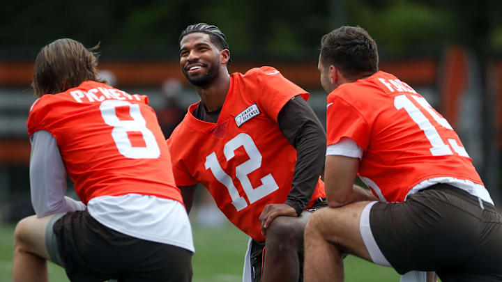 Browns quarterbacks Shedeur Sanders (12), Kenny Pickett (8) and Joe Flacco (15) talk during minicamp June 10, 2025, in Berea.